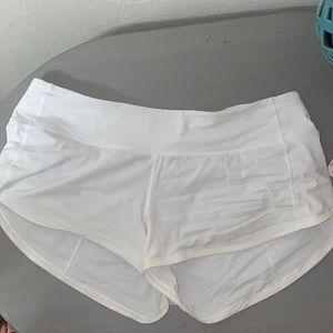 White Lululemon 2.5” speed shorts.